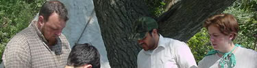Visitors talking with ranger in pioneer clothing