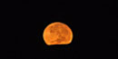 Harvest moon rising over the Pacific Ocean