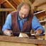 A volunteer working in the fort's Carpenter Shop