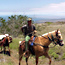 Park Ranger on a horse pulling a pack mule riding up from the coast.