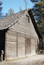 Front of wooden log building.