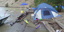 These folks thought their campsite was far enough away from the water, but woke to find toys and coolers floating away.