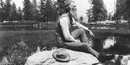 john muir posing on rock in black and white photo