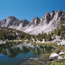 Mountain lake with snow covered peaks in distance