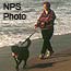 Woman walking a dog on a beach
