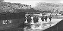 Assault troops of the 3rd Marine Division wade ashore under fire at Asan Beach