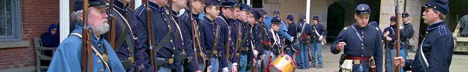 Line of Civil War re-enactors in uniforms with guns at Fort Point