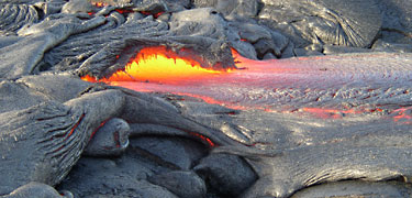 Lava flows like a river out of a hardened crust. NPS photo by Katja Chudoba. Lava flows like a river out of a hardened crust. NPS photo by Katja Chudoba.