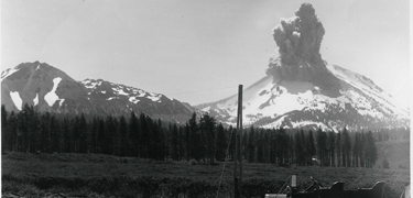 historic black and white photograph of Lassen peak erupting in 1915