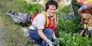 A female volunteer works with park staff on revegetation project A female volunteer works with park staff on revegetation project