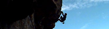 A climber dangles from an overhang on Discovery Wall