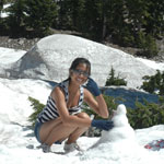 A young woman makes a spring snowman