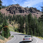 Diamond Peak rises above a vehicle on the park highway