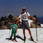 Adult and child skier on summit of Lassen Peak