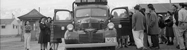 Packing up the bus at Manzanar. Photo by Ansel Adams.