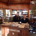 Photo of Interns Kristen and Cooper staffing the Information Table in the Visitor Center.