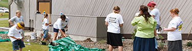 Volunteers planting native shrubs at Spalding visitor center