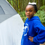 Girl poses in front of a tent during a Seattle Parks & Recreation Event Photo: NPS/©David Snyder