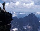 Photo of a hiker looking out over the peaks of Glacier National Park
