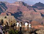 Photo of visitors looking out over the Grand Canyon