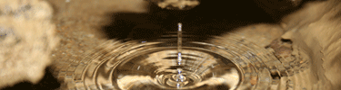Water drops into a pool inside the cave