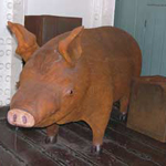 A brown-colored pig in the pantry aboard BALCLUTHA.