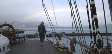 A rainbow over San Francisco Bay seen from Balclutha's stern.