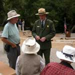A ranger talks to three visitors at Solstice Canyon near the amphitheater.