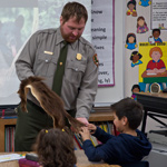 Rangers share the American Black Bear with elementary students.