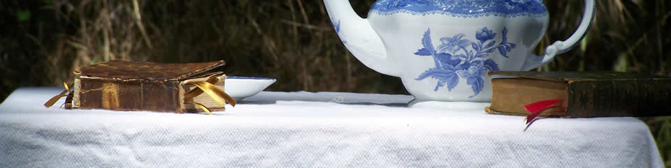 bible sitting next to a teapot 