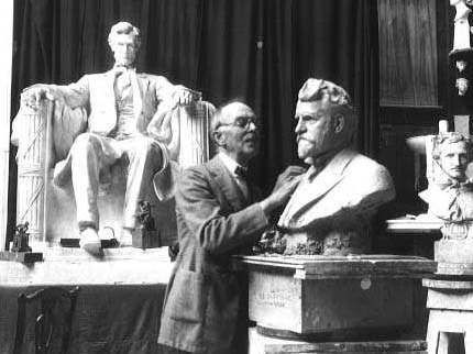 Photo of Daniel Chester French at work in his studio, with his sculpture of the seated Abraham Lincoln in the background