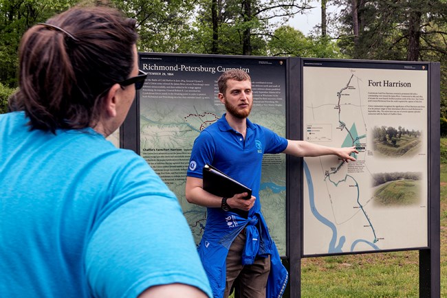 An intern pointing at a battlefield map