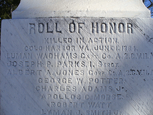 white stone monument engraved with names of fallen soldiers