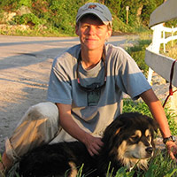 woman sitting with a black and tan dog woman sitting with a black and tan dog