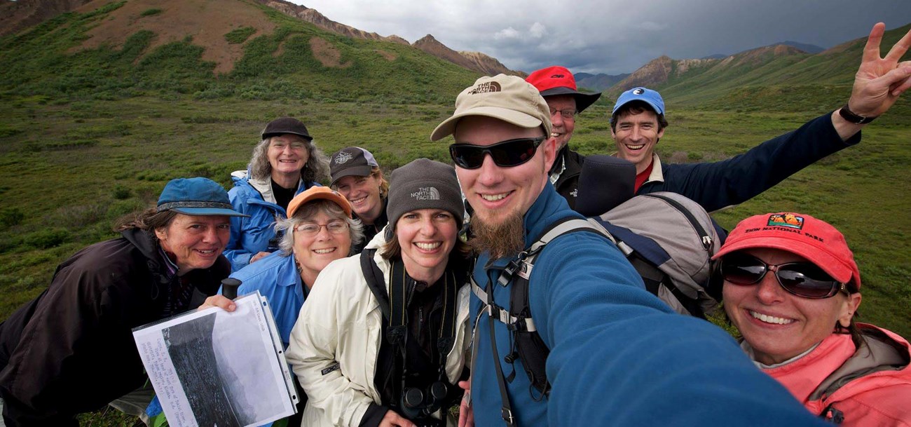 a group of hikers smile excitedly