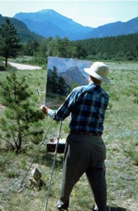 Photo Plein Air artist painting in a meadow at Rocky Mountain National Park.