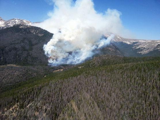 Photo from flight over the Big Meadows Fire on the afternoon of June 11, showing smoke and flames in the distance.