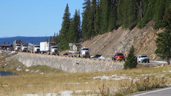 A nine vehicle convoy of tractor trailers, a truck mounted rock crusher, pickup trucks and pilot vehicles cross Trail Ridge Road in Rocky Mountain National Park today.