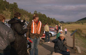 a photo of an Elk Bugle Corps volunteer assisting a visitor