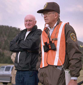 a photo of an Elk Bugle Corps volunteer instructing a visitor