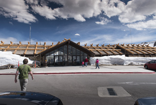 Photo of Alpine Visitor Center in early June with snow up to the roof. 