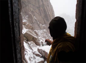 Photo Longs Peak hiker assessing conditions at the Keyhole.