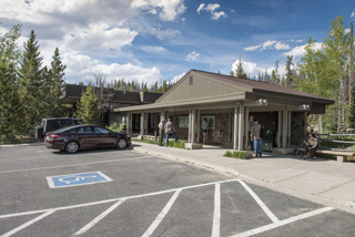 Photo of Kawuneeche Visitor Center under a bright blue sky. 