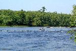People relax on inner tubes across the wide river