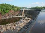 Concrete face of dam with rocks below