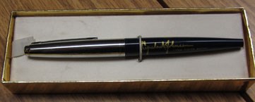 Silver and blue writing pen with signature of President Johnson