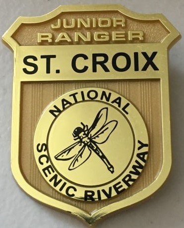 An image of the St. Croix Riverway Junior Ranger Badge, embossed with a dragonfly.