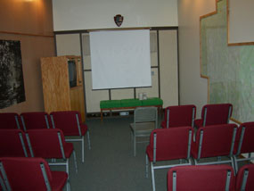 room with chairs facing screen