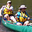 Closeup of two women with lifejackets canoeing