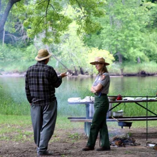 A Park Ranger shares stories of the river with a park visitor. NPS photo